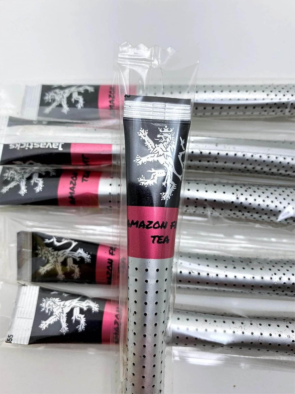 Amazon Fruit Tea sticks in their individual wrappers on a plain background