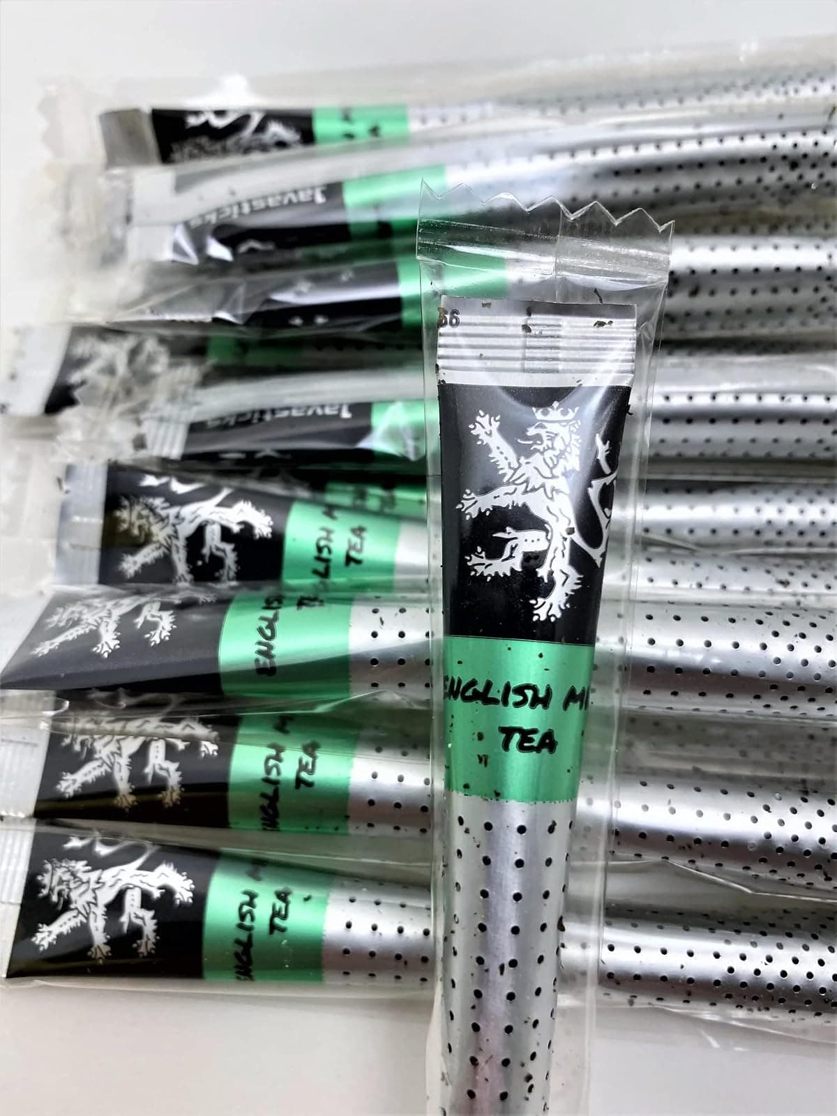 English Mint Tea sticks in their individual wrappers on a plain background