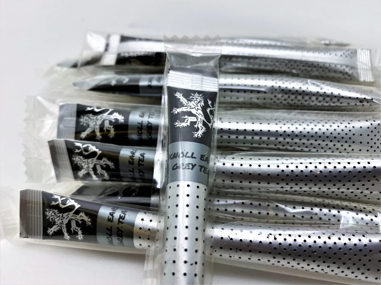 Knoll Earl Grey Tea sticks in their individual wrappers on a plain background
